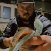Daniel holding a fish caught with a White Monster Energy RX Slug.