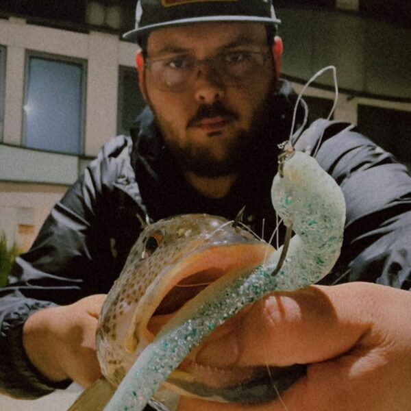 Daniel holding a fish caught with a White Monster Energy RX Slug.